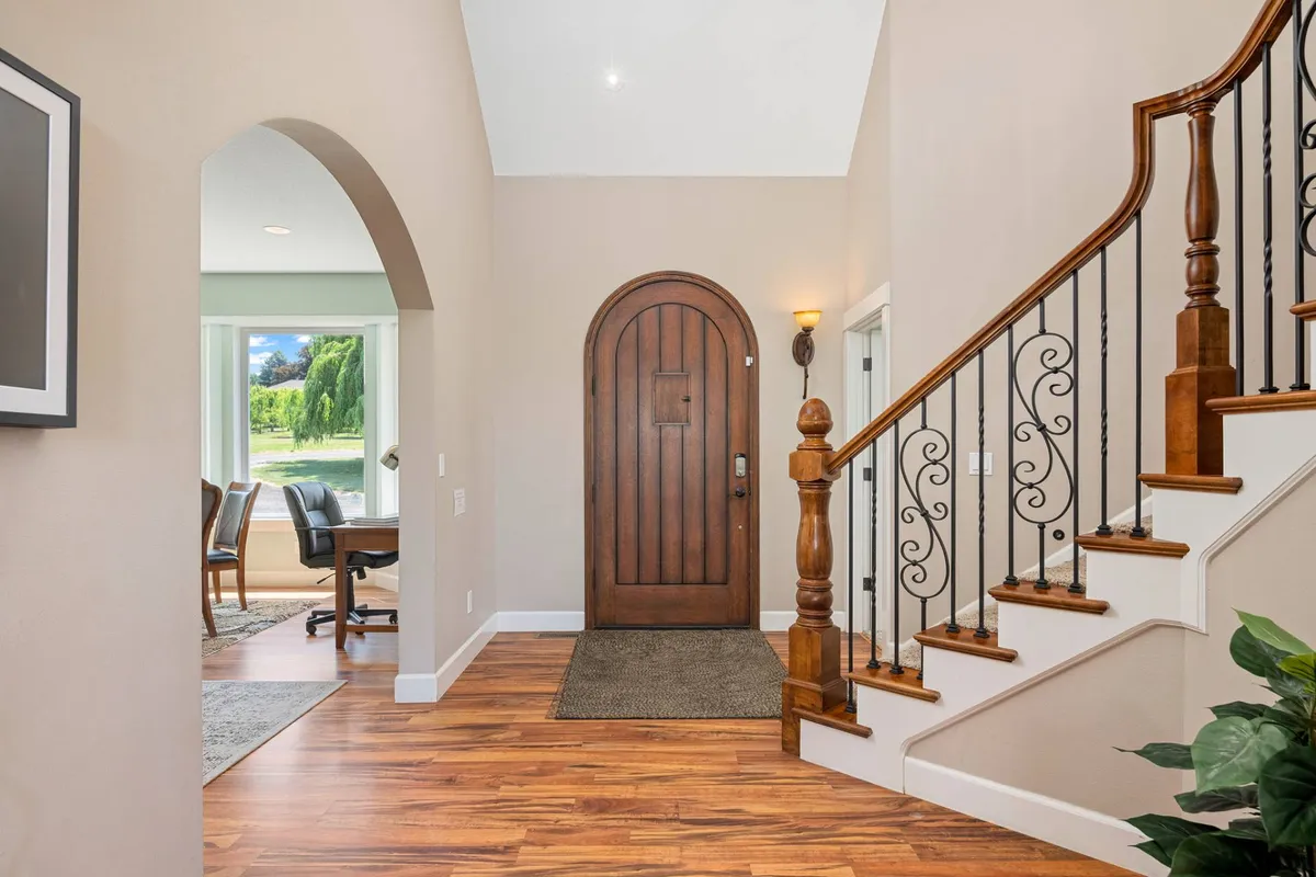 An arched entrance with a sturdy wooden door and staircase signifies the chateau’s welcoming entry point. The architectural elements evoke a sense of arrival and anticipation for the experiences that await outside these doors.